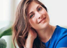 attractive-young-woman-sitting-at-a-table-P7FWDED.jpg